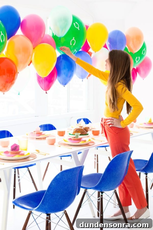 Vibrant Modern Friendsgiving Ideas for a Colorful Celebration 2 A person near a table and balloons