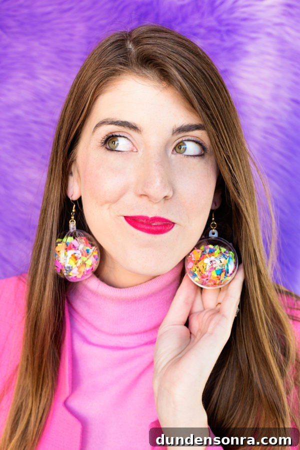 A close-up of a woman wearing confetti earrings