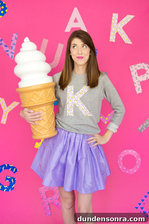 Custom Monogram Sweatshirts: DIY Graphic Initial Design Guide 12 A woman wearing a K crewneck and holding a big ice cream