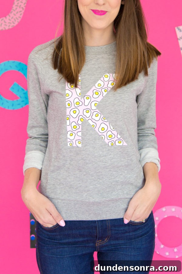 Custom Monogram Sweatshirts: DIY Graphic Initial Design Guide 9 A woman wearing a crewneck with a K on it