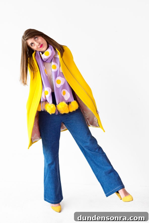 A person wearing a purple scarf and yellow jacket