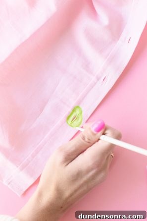 DIY Avocado Buttons: How to Make Stylish Avocado Jewelry at Home 7 Someone painting green on a shirt