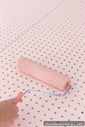 Creative Pegboard DIY Ideas for Stylish Home Organization 7 Someone painting wood pink