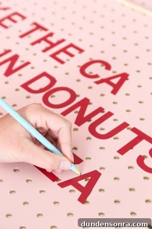 Creative Pegboard DIY Ideas for Stylish Home Organization 9 A pink board with red writing on it