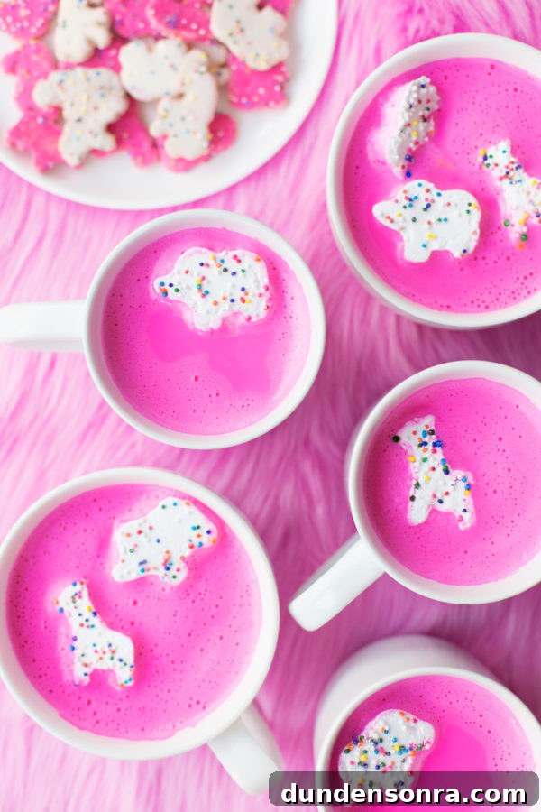 Mugs with pink drinks and animal cookie marshmallows in it