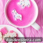 A mug with a pink drink in it