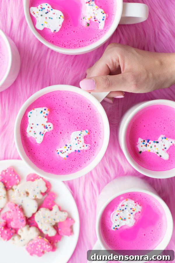 Mugs with pink liquid and circus animal cookie marshmallows in them