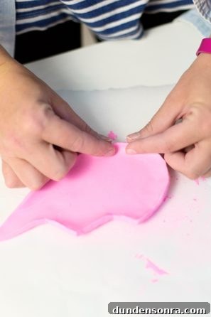 Someone playing with pink clay