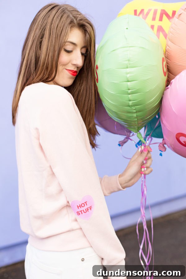 Conversation Heart Pattern Sweatshirt with Stylish Elbow Patches 2 A woman holding balloons