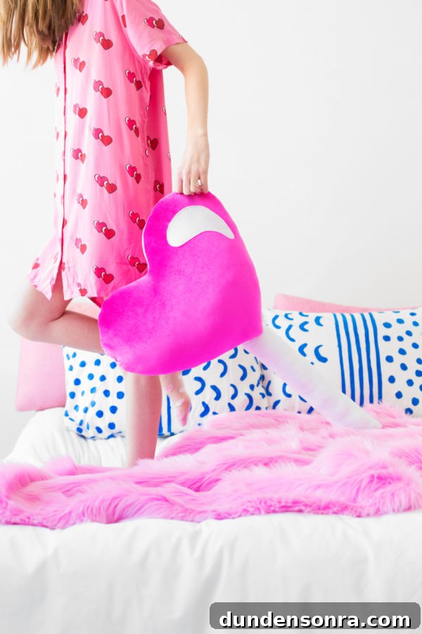 Someone holding a heart-shaped lollipop pillow