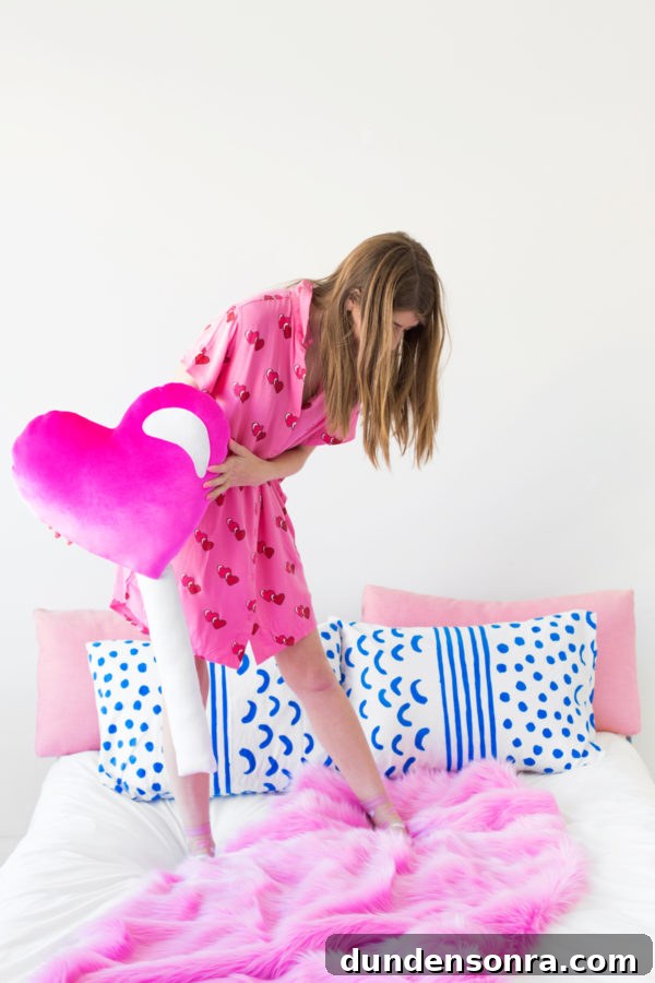 A woman holding a heart pillow