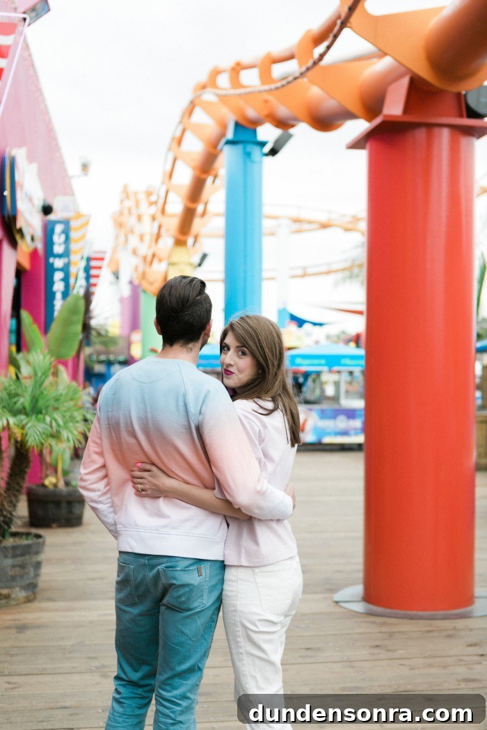 photo of couple with rollercoaster behind them