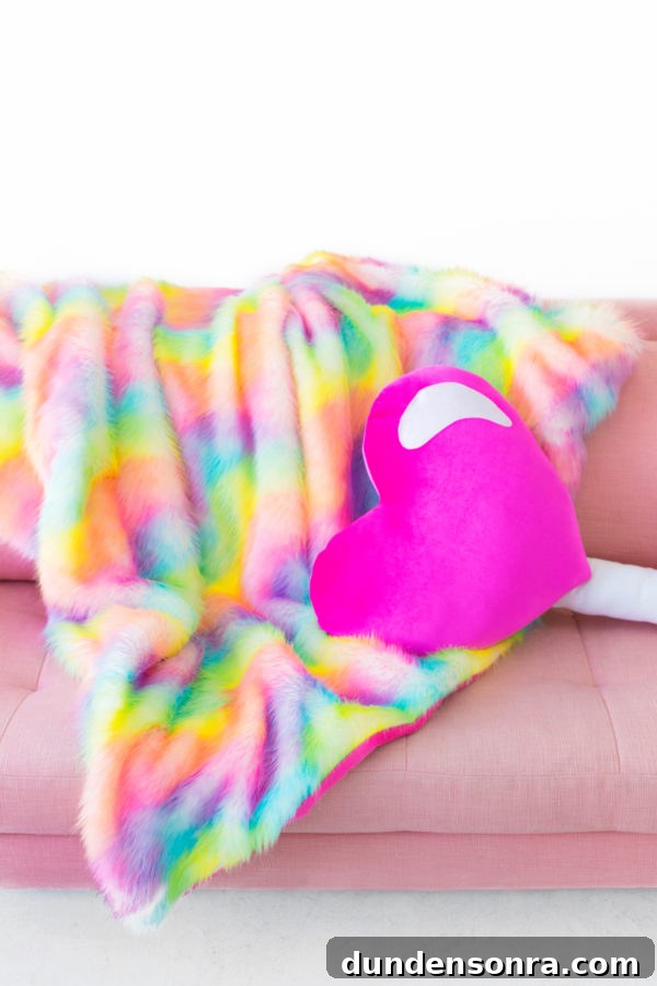 Pink heart pillow and rainbow fur blanket