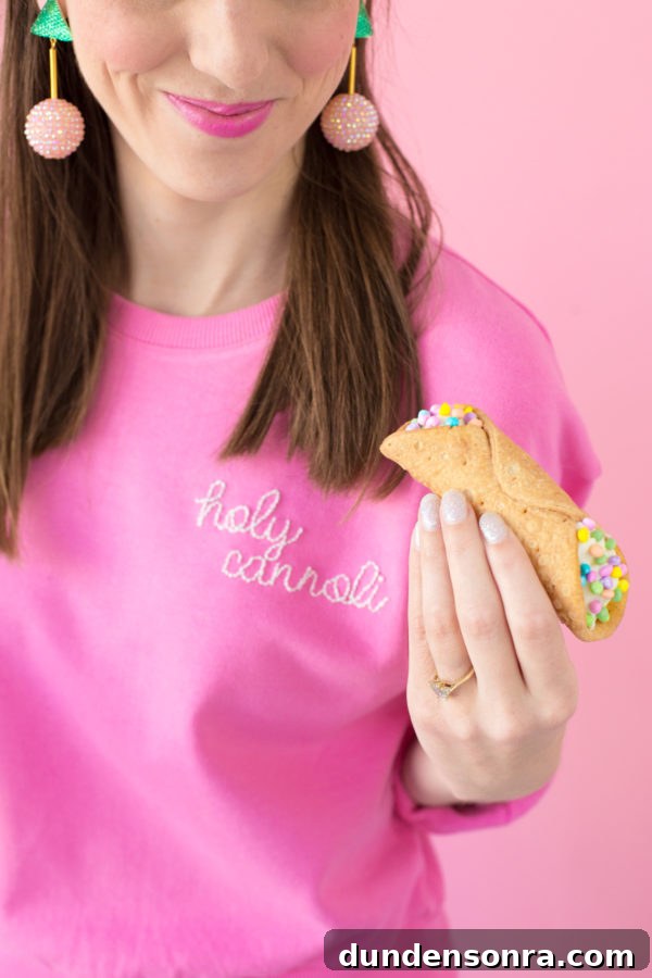 DIY Embroidered Sweatshirt: Simple Embroidery Hack for Perfect Stitches 17 Someone holding a cannoli