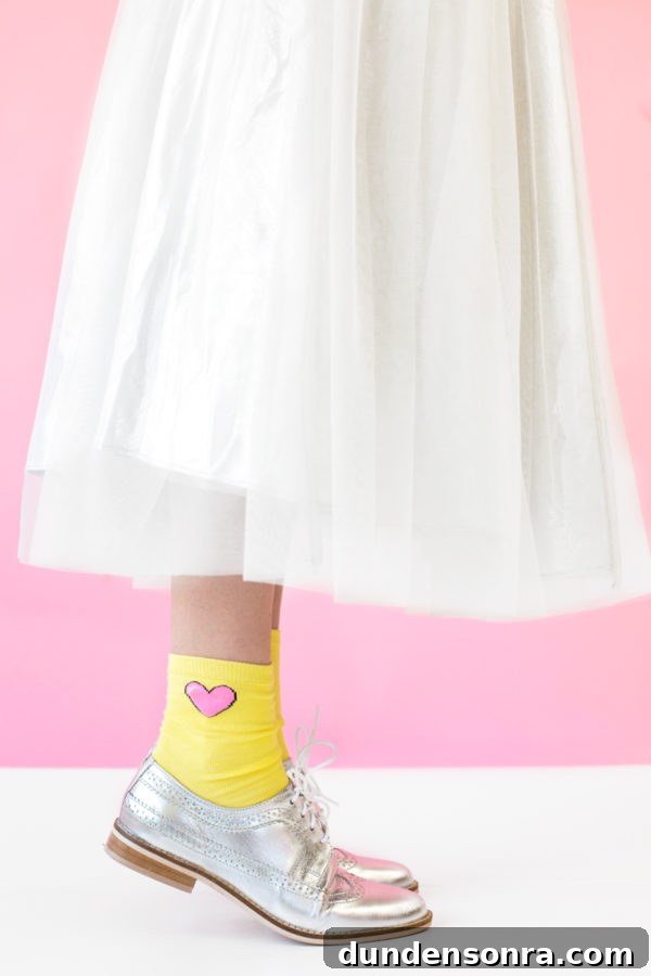 The end of a white dress and yellow socks