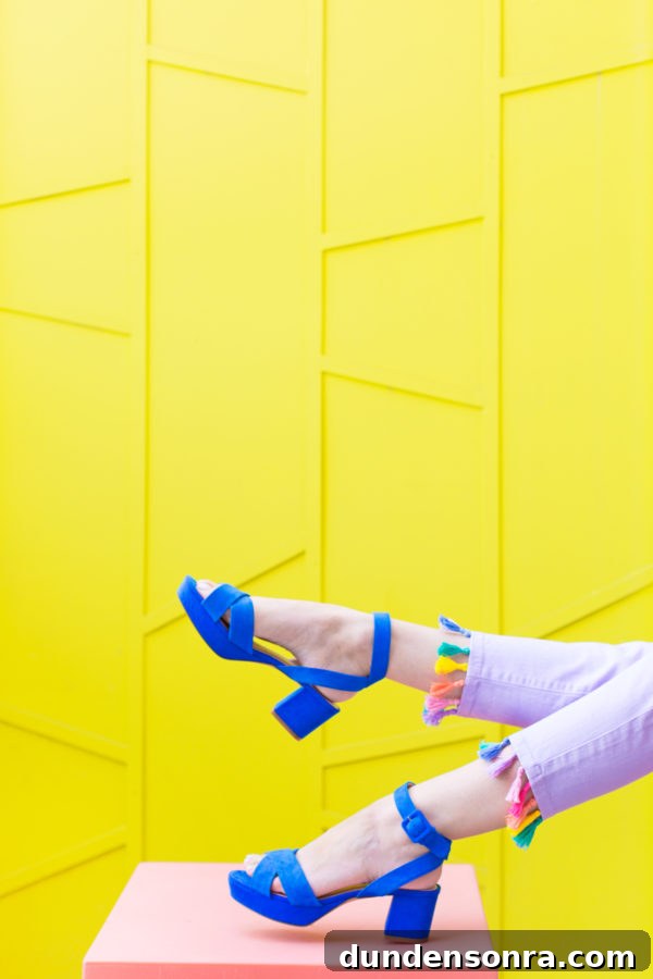 Blue heels in front of a yellow wall