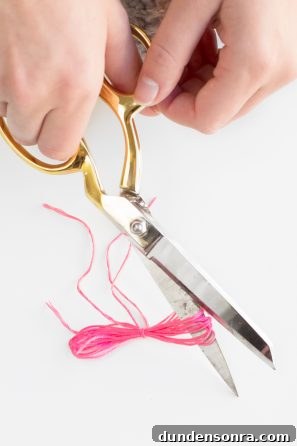 DIY Tassel Jeans: How to Add Trendy Tassel Trim to Your Denim 8 Scissors and pink string