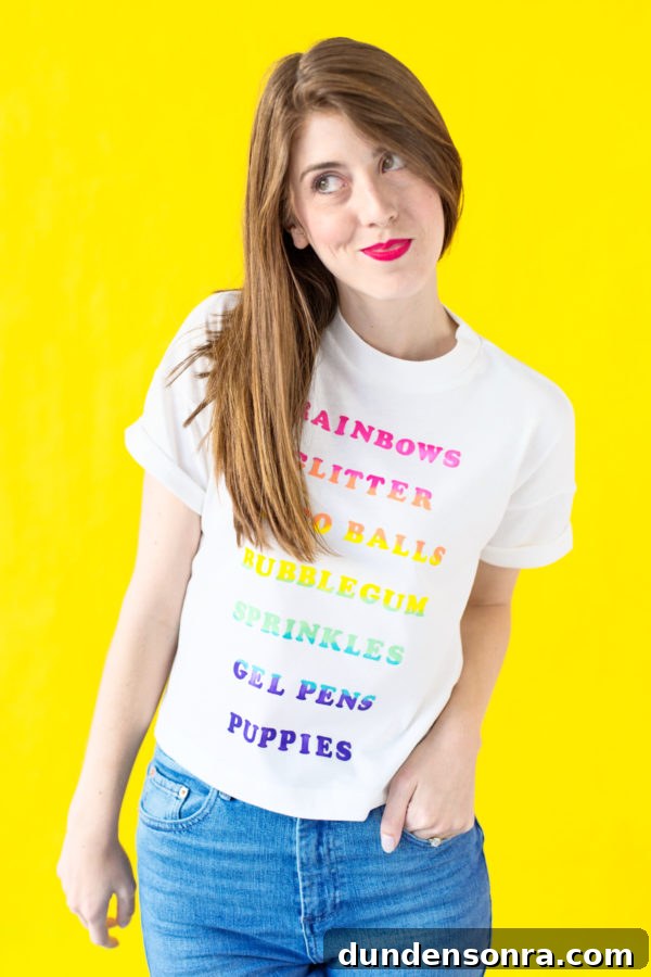 A woman wearing a shirt with rainbow words