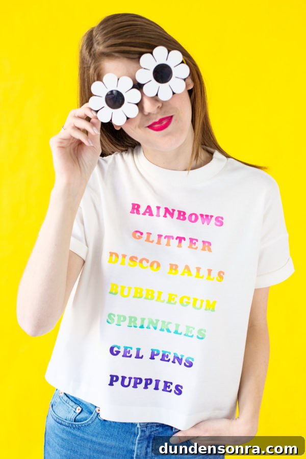 A woman wearing a white shirt with rainbow words