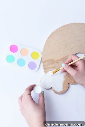 Someone painting a wood board white