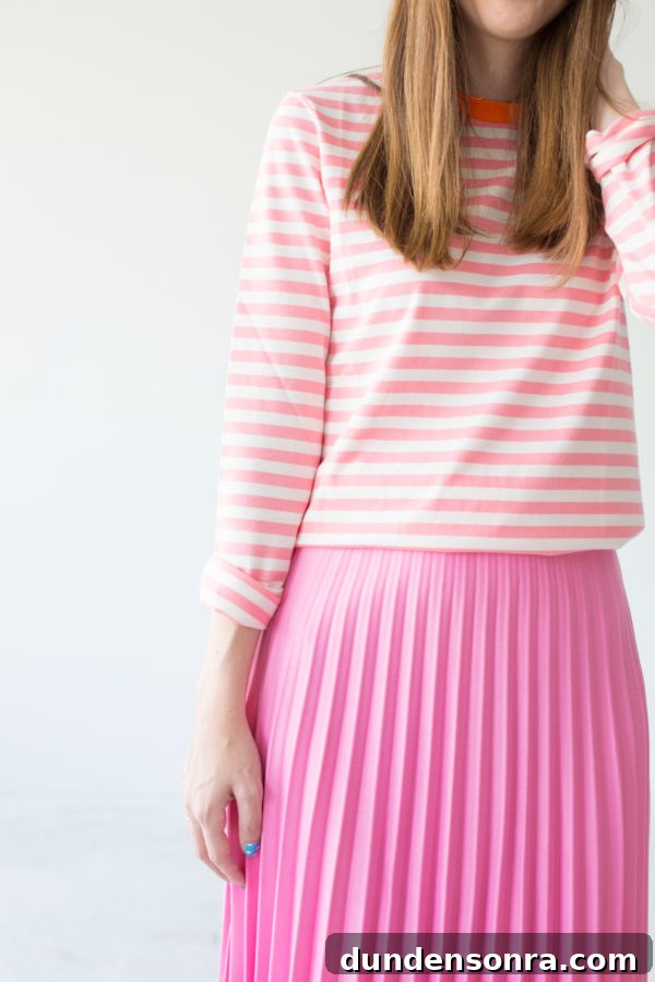 A girl in a pink shirt and pink skirt