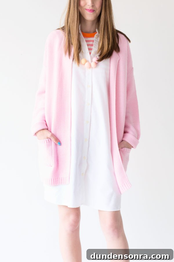 A girl wearing a white dress and pink jacket