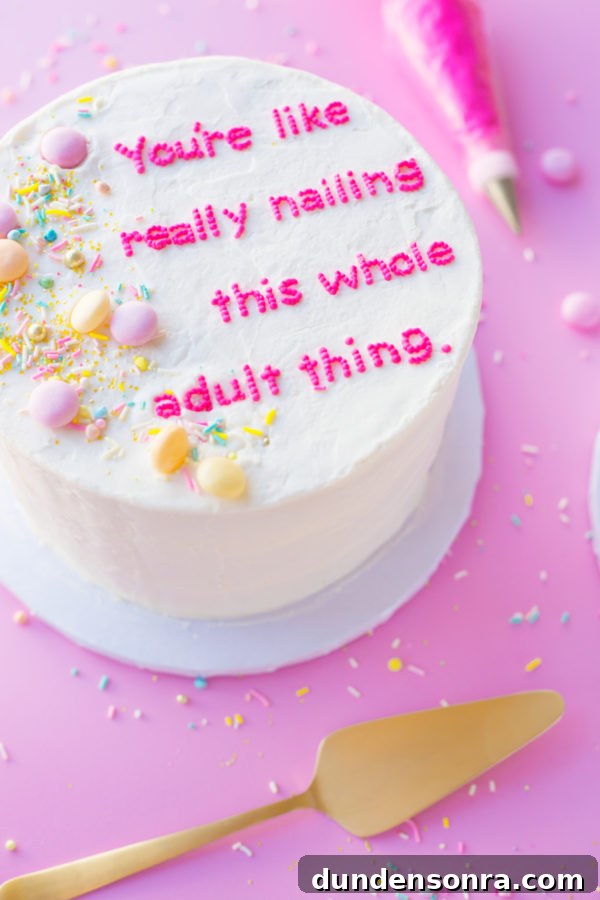A cake with writing and sprinkles 