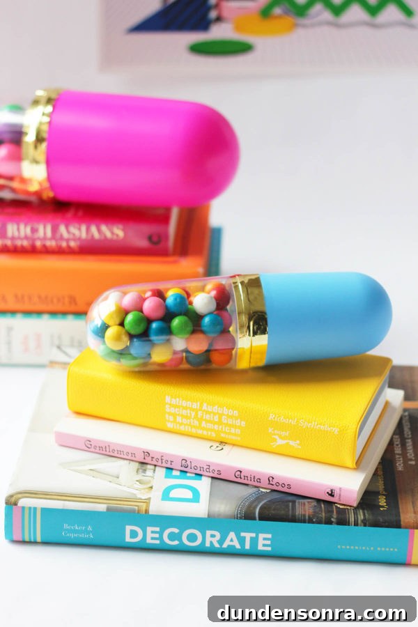 DIY Sprinkle Pill Paperweight: Make a Colorful Resin Desk Weight 4 Sprinkle pill on a stack of books