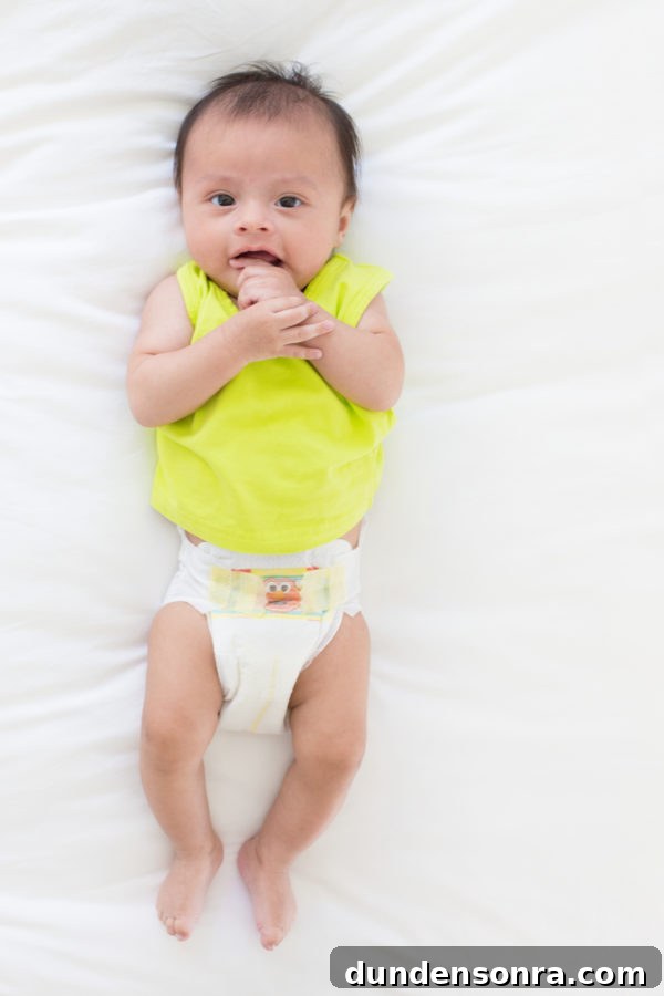 A baby sitting on a bed