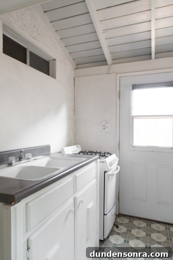A kitchen with a sink and a window