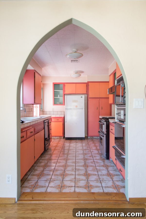 A kitchen with a pink cabinets