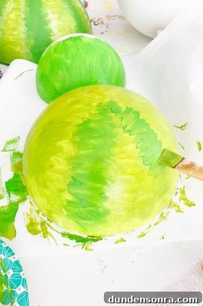 How to Make Giant Foam Fruit Decorations for Parties 5 Someone painting a giant fruit