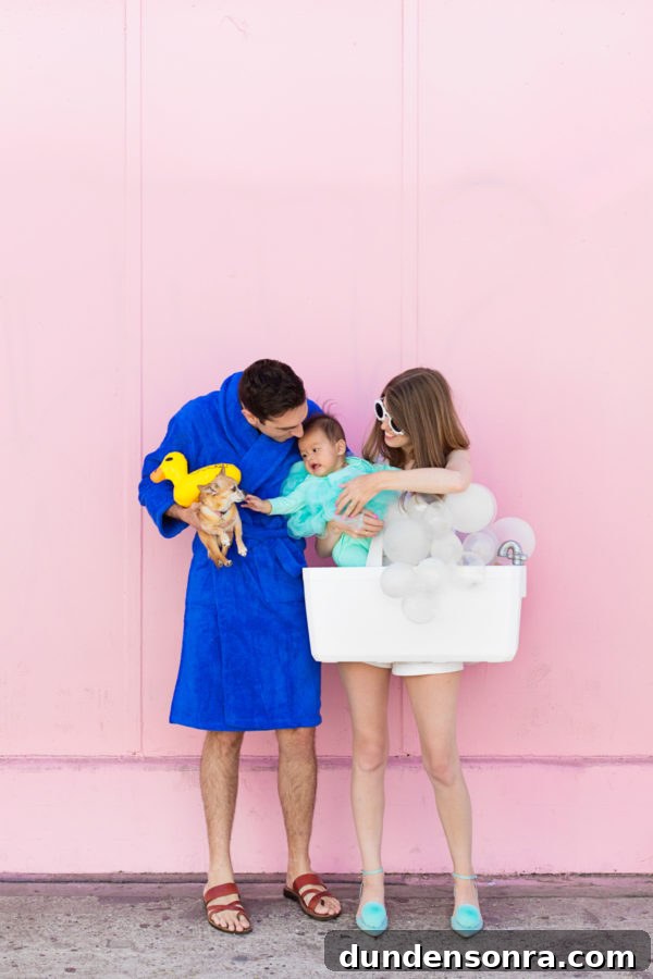 A family dressed in costumes in front of a pink wall