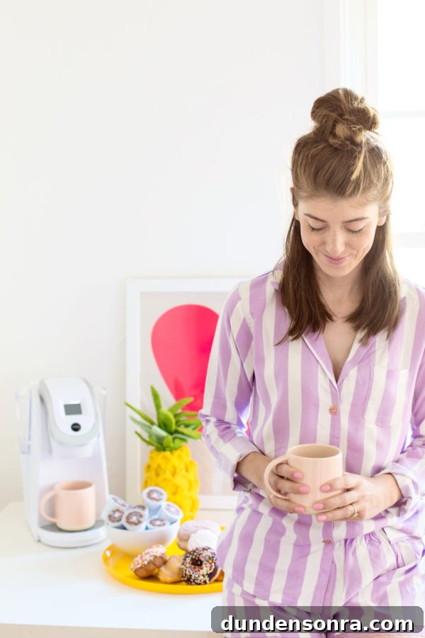 DIY Donut Button Pajamas and Our New Weekend Morning Routine 4 A woman holding a cup of coffee on a table, wearing purple and white stripped shirt