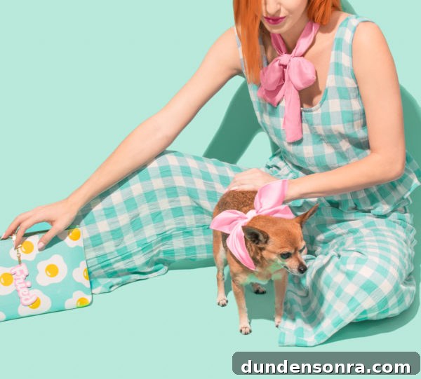 Someone holding an egg clutch and petting a dog