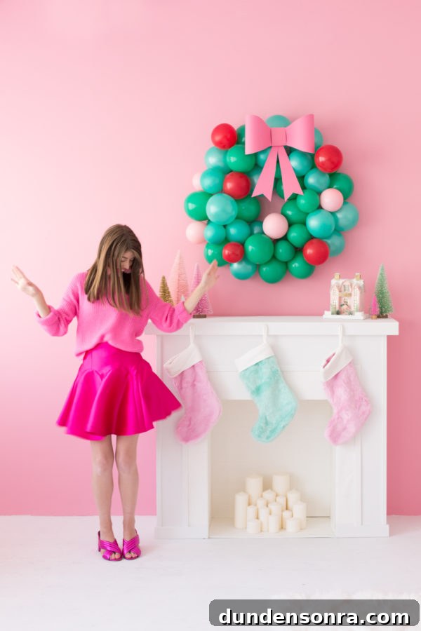 A girl in a pink dress next to a fire place