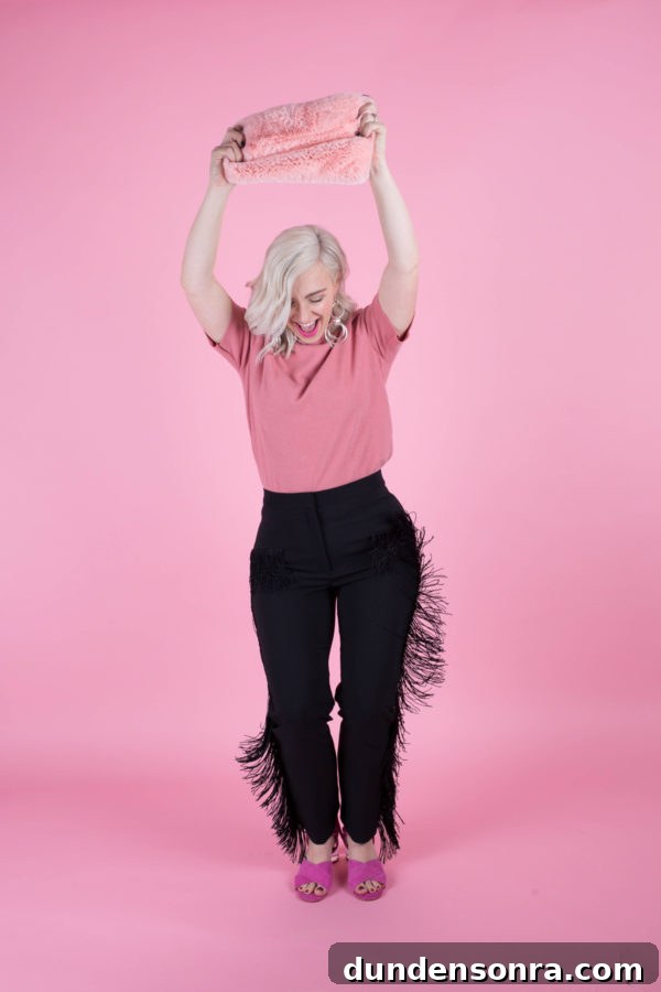 A woman in a pink shirt and black pants
