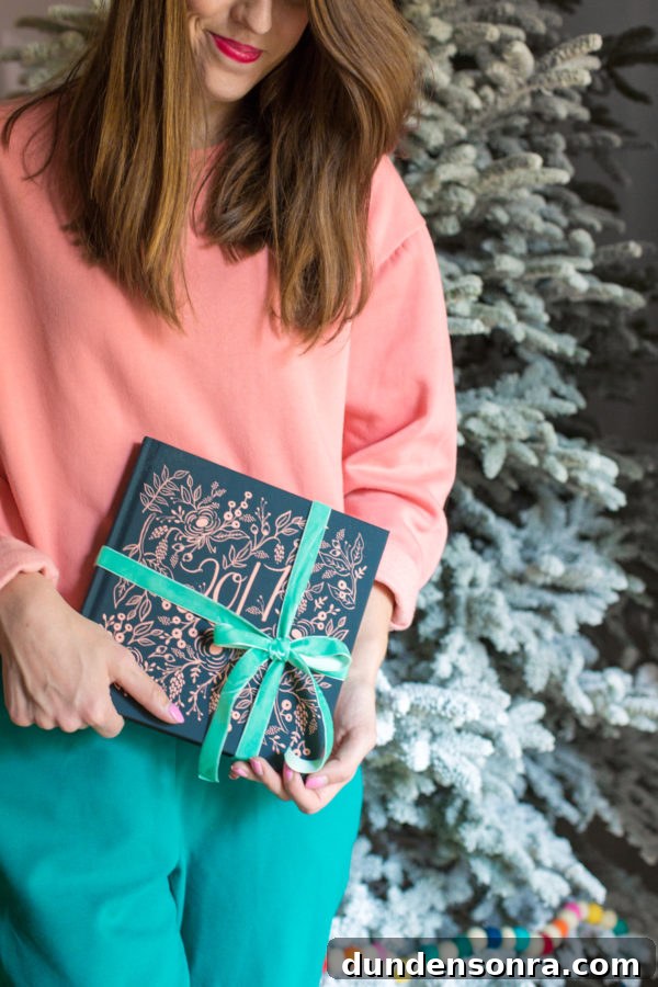 Someone holding a book with ribbon