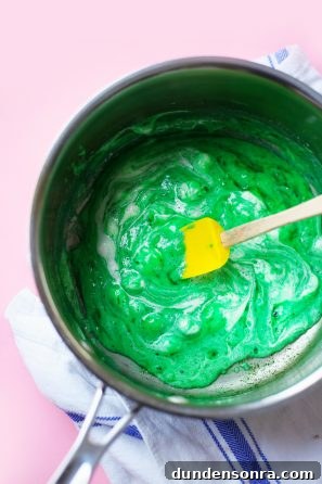 Colorful Rainbow Rice Krispie Treats Recipe for Parties 6 Green frosting in a bowl