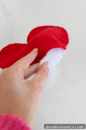 Someone stuffing something with cotton