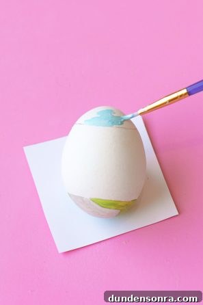 DIY Palm Springs Easter Egg Decor: Bright, Midcentury Craft Ideas 11 Someone painting an egg