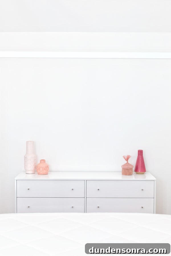 A white dresser with pink decor