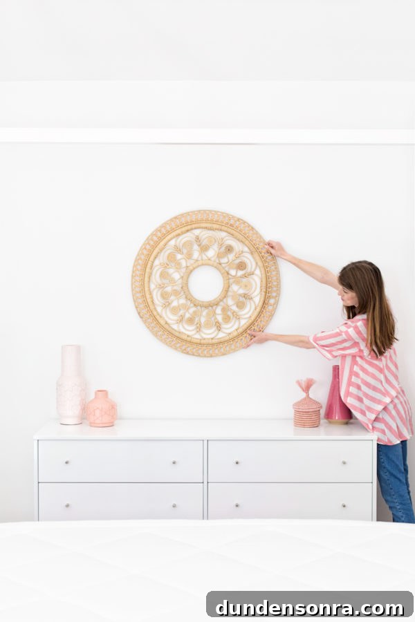 A person holding up a piece of decor