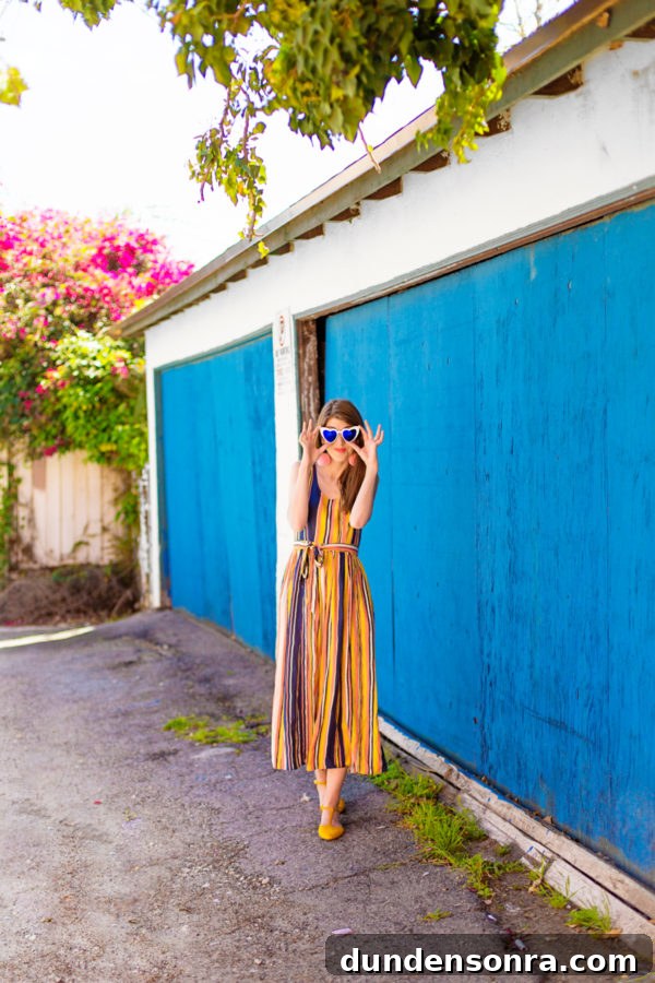A person standing in front of a blue building