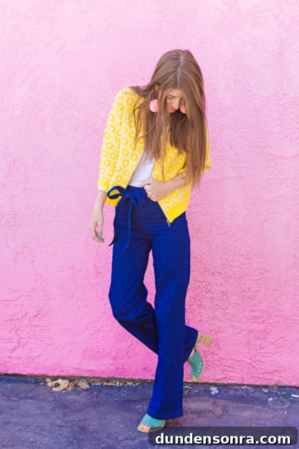A person standing in front of a pink building