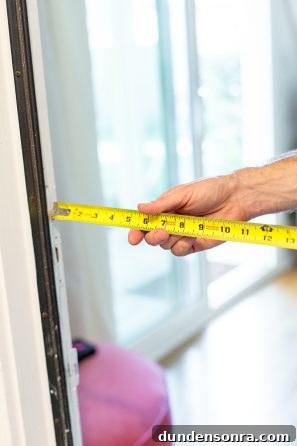 DIY Guide: Transform a Pink Closet with French Doors 4 Someone holding a ruler