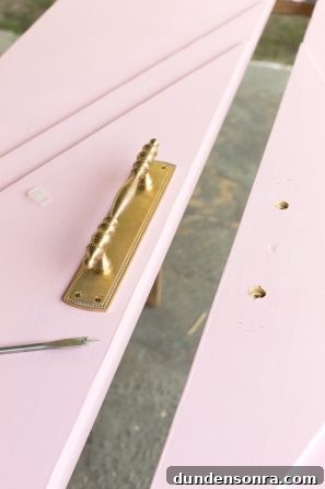 DIY Guide: Transform a Pink Closet with French Doors 9 Gold handle on a pink door
