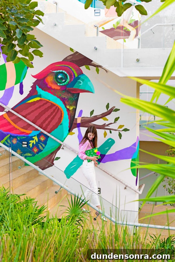 A woman in front of a colorful wall