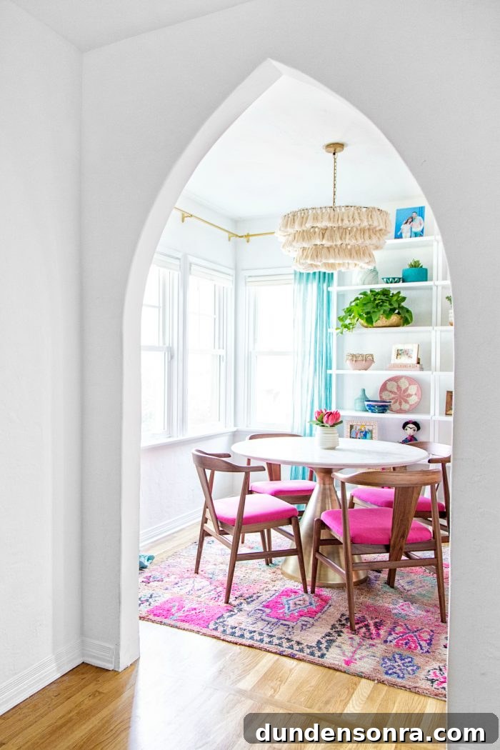 A dining room with pink chairs