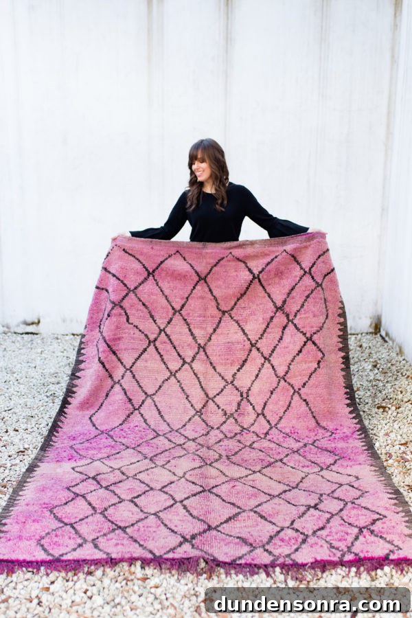 Someone holding a pink rug